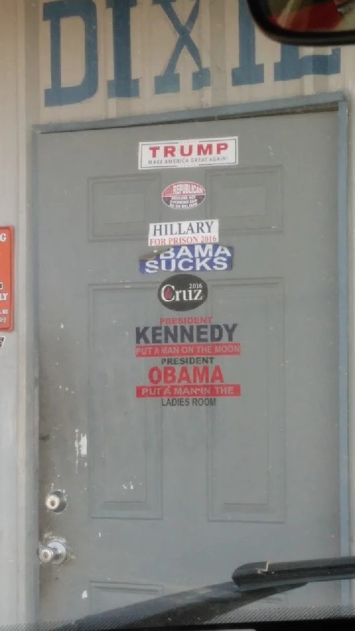 Door covered in political stickers at Dixie Auto Parts.