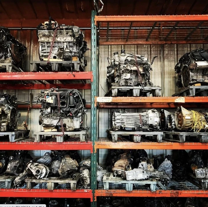 Engine parts neatly organized on metal shelves.