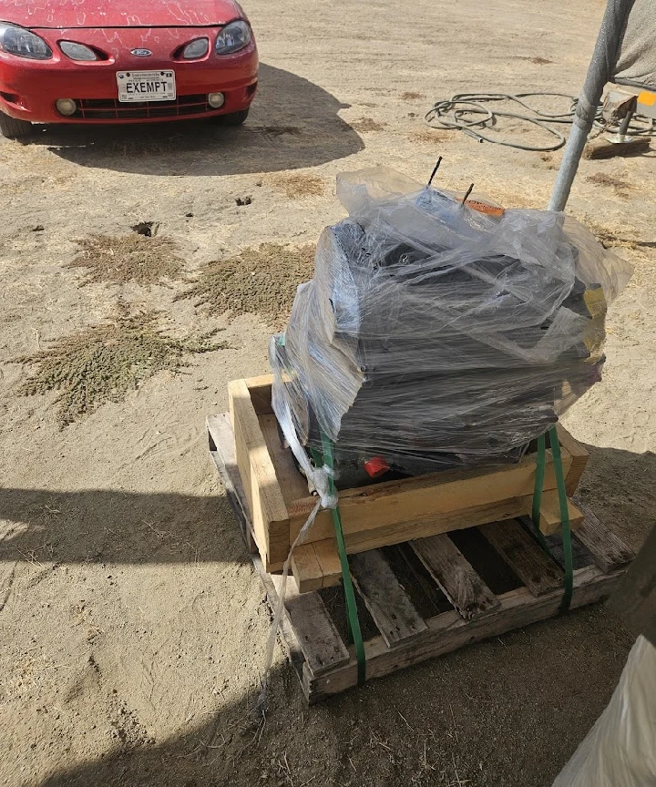 Engine parts on a pallet, wrapped in plastic.