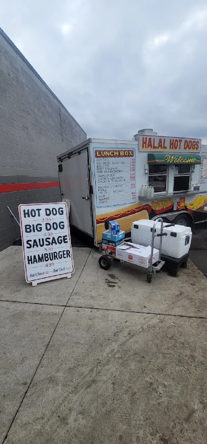 Food truck offering hot dogs and snacks outside.