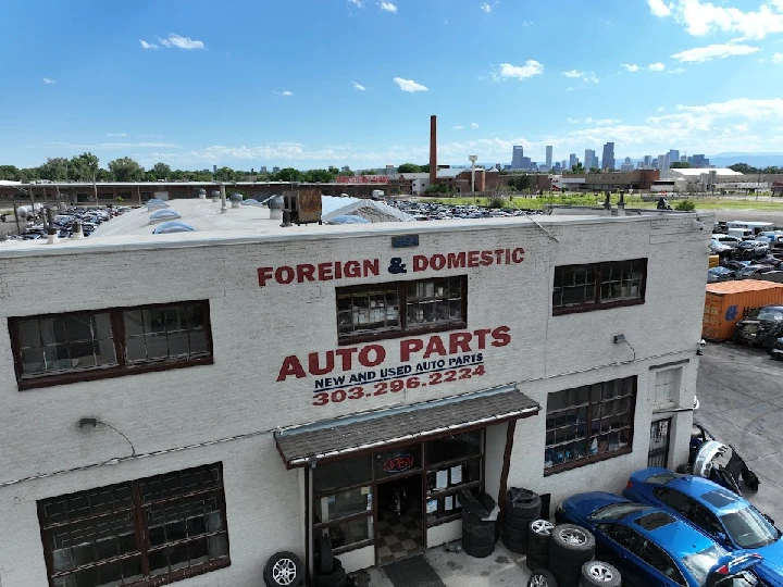 Foreign Used Auto Parts building with vehicles outside.