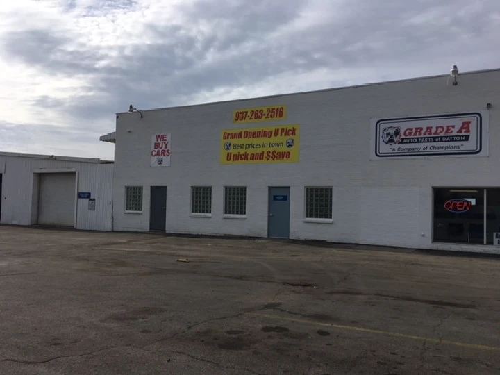 Grade A Auto Parts storefront with open signs.