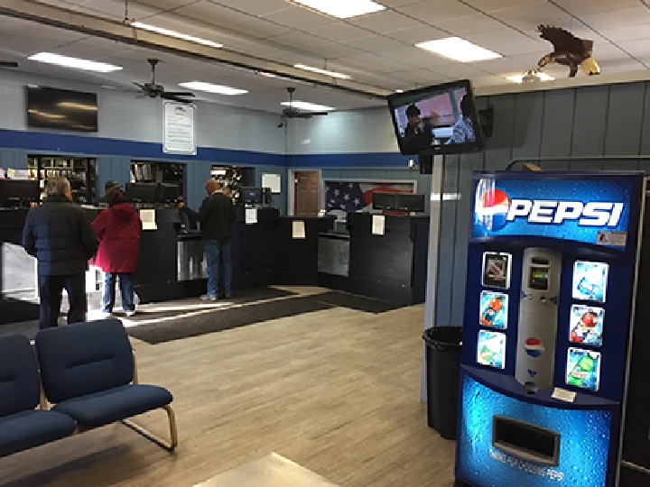 Interior of US Auto Supply with customers and vending.