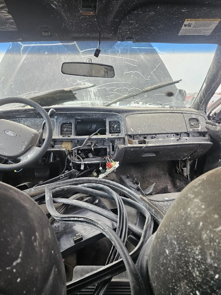 Interior of a wrecked vehicle filled with debris.