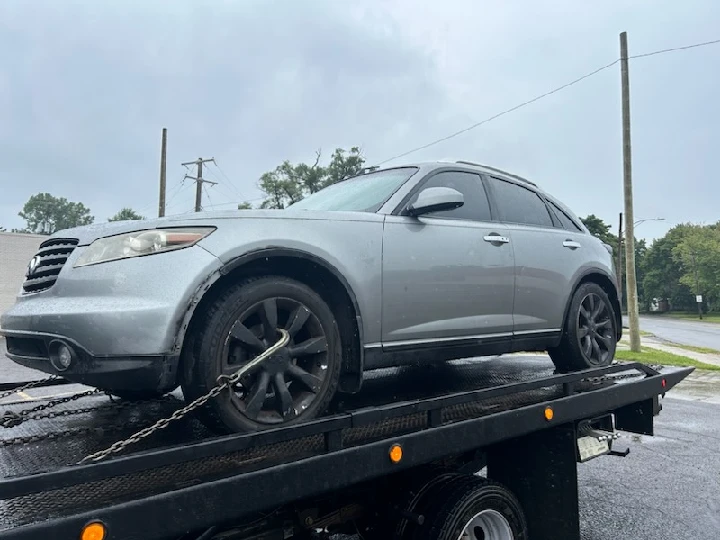 Junk car being towed for cash sale.