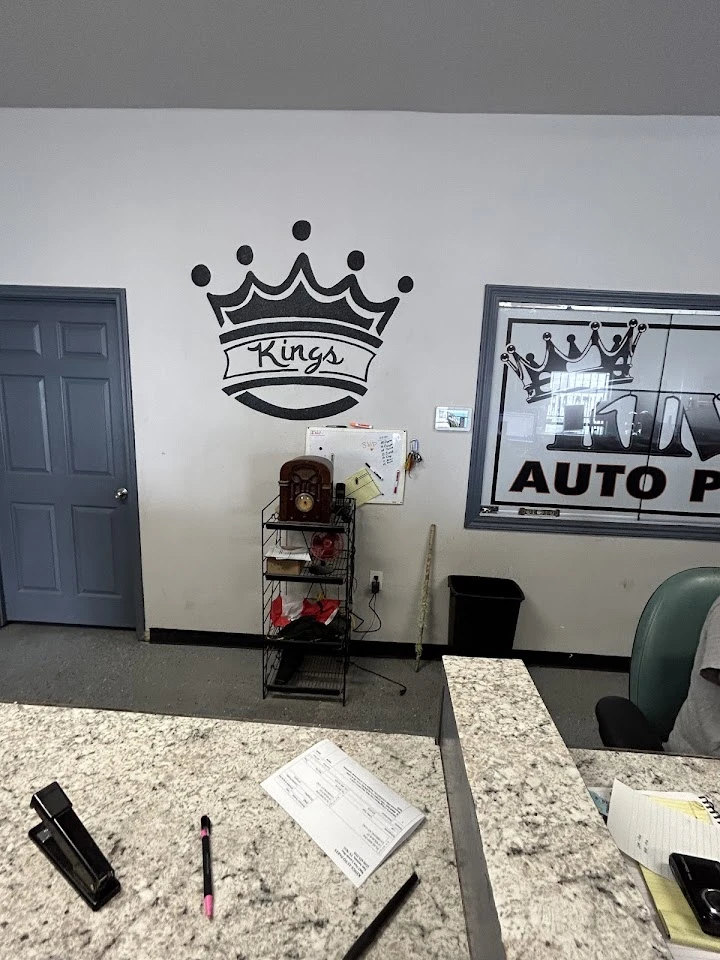 Kings Auto Parts reception with logo and paperwork.