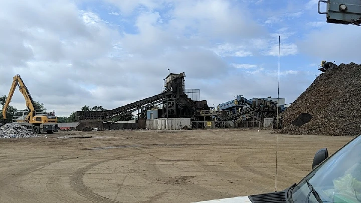 Metal recycling facility with heavy machinery.