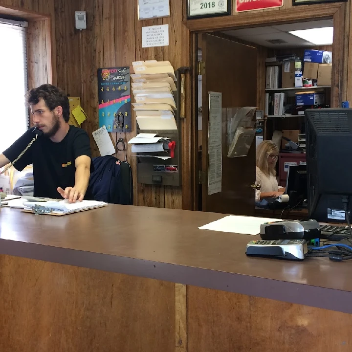 Office scene at AAA Parts & Salvage with staff.