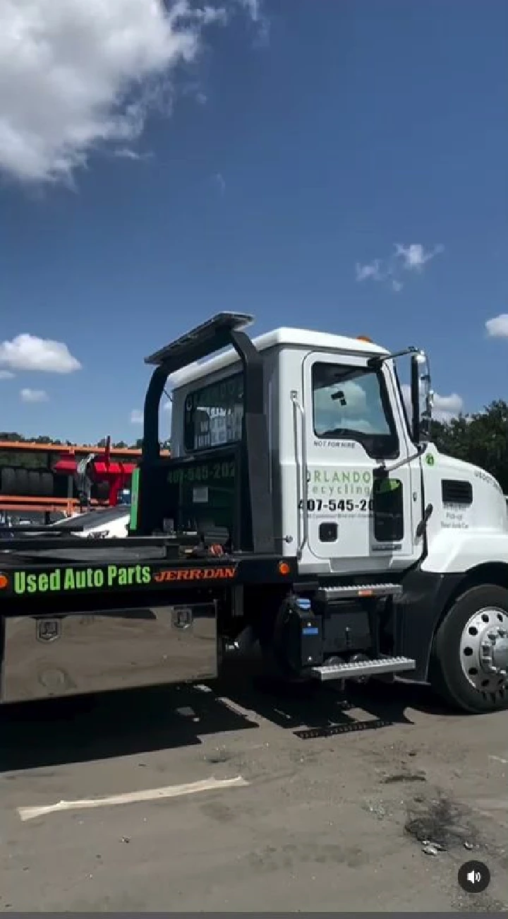 Orlando Auto Parts truck at recycling yard.