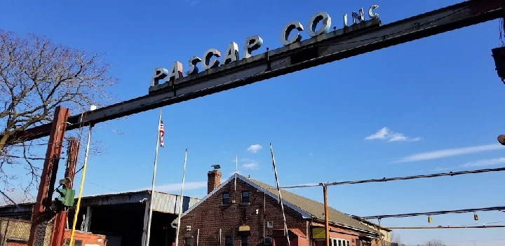 Pascap Co. Inc. entrance sign against a blue sky.