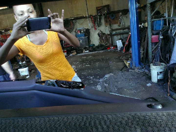 Person taking a photo in an auto parts shop.