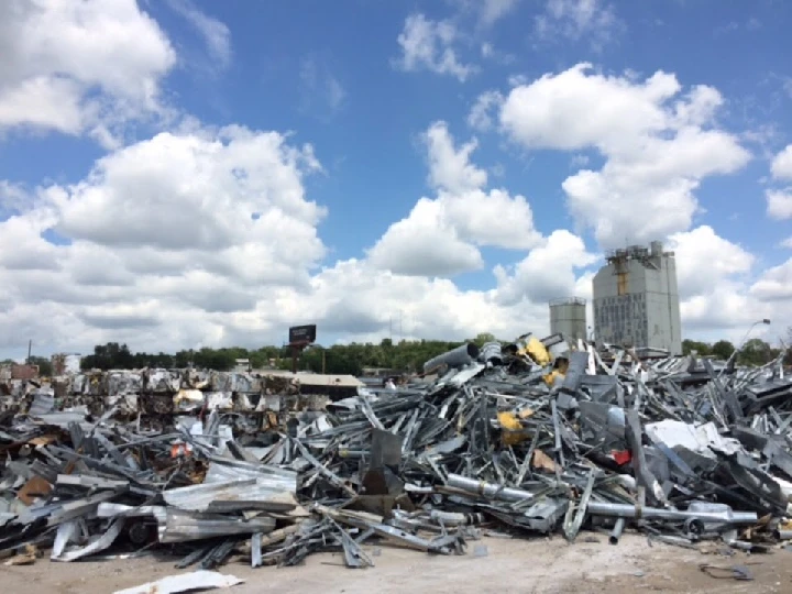 Piles of scrap metal under a blue sky.