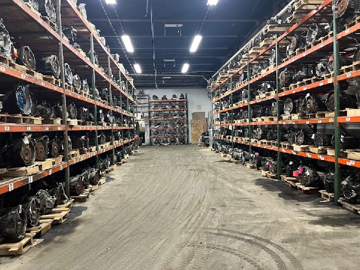 Rows of salvaged auto parts in a warehouse.