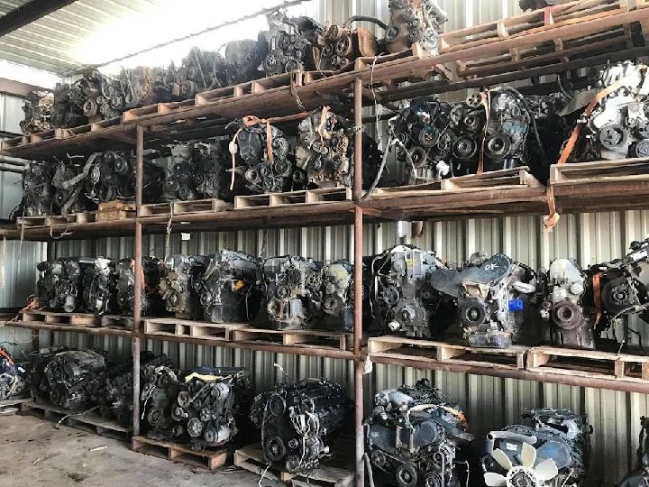 Rows of used engines on shelves in a warehouse.