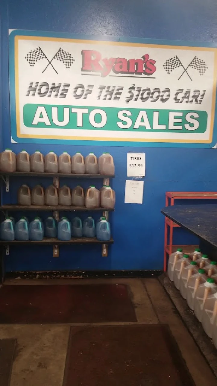 Ryan's Auto Sales sign with displayed products.