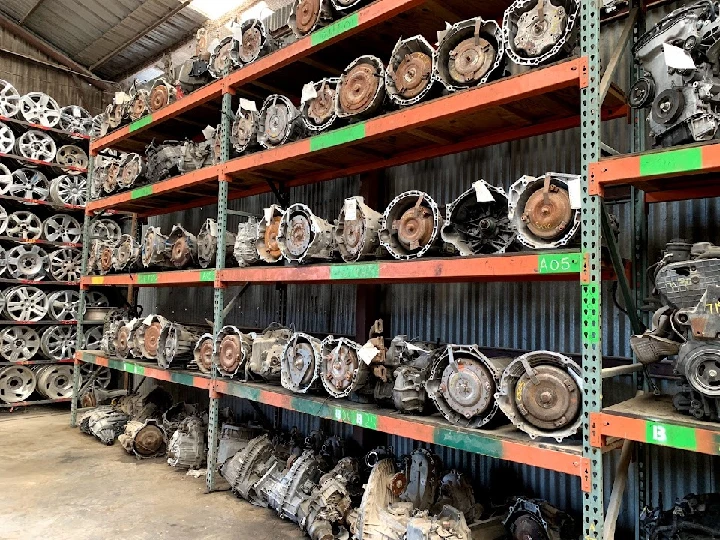 Shelves of auto parts and engines at Brothers Auto Parts.