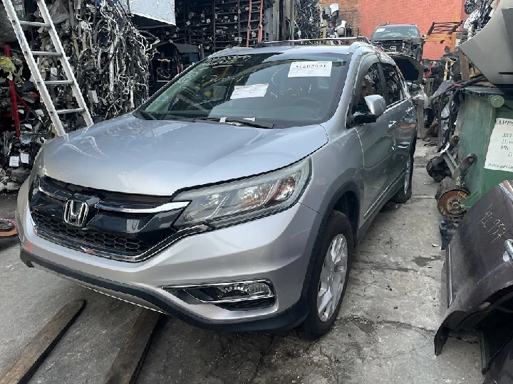 Silver Honda SUV at auto salvage yard.