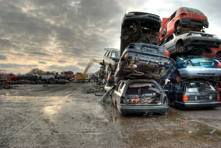 Stacked junk cars in a recycling yard.