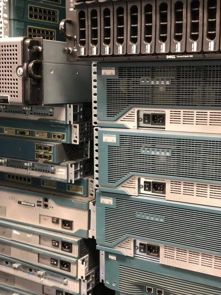 Stacked network equipment and servers in a rack.