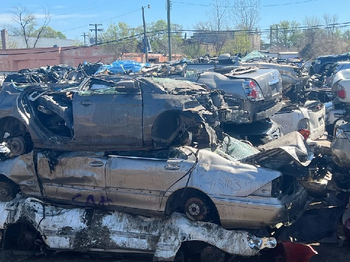 Stacked wrecked cars at an auto recycling yard.