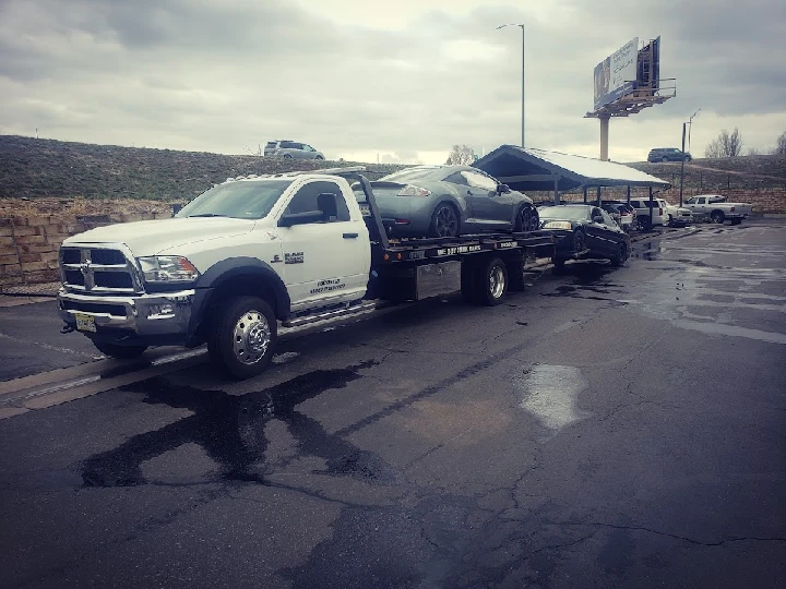 Tow truck loaded with junk cars at A1 Auto Recycling.