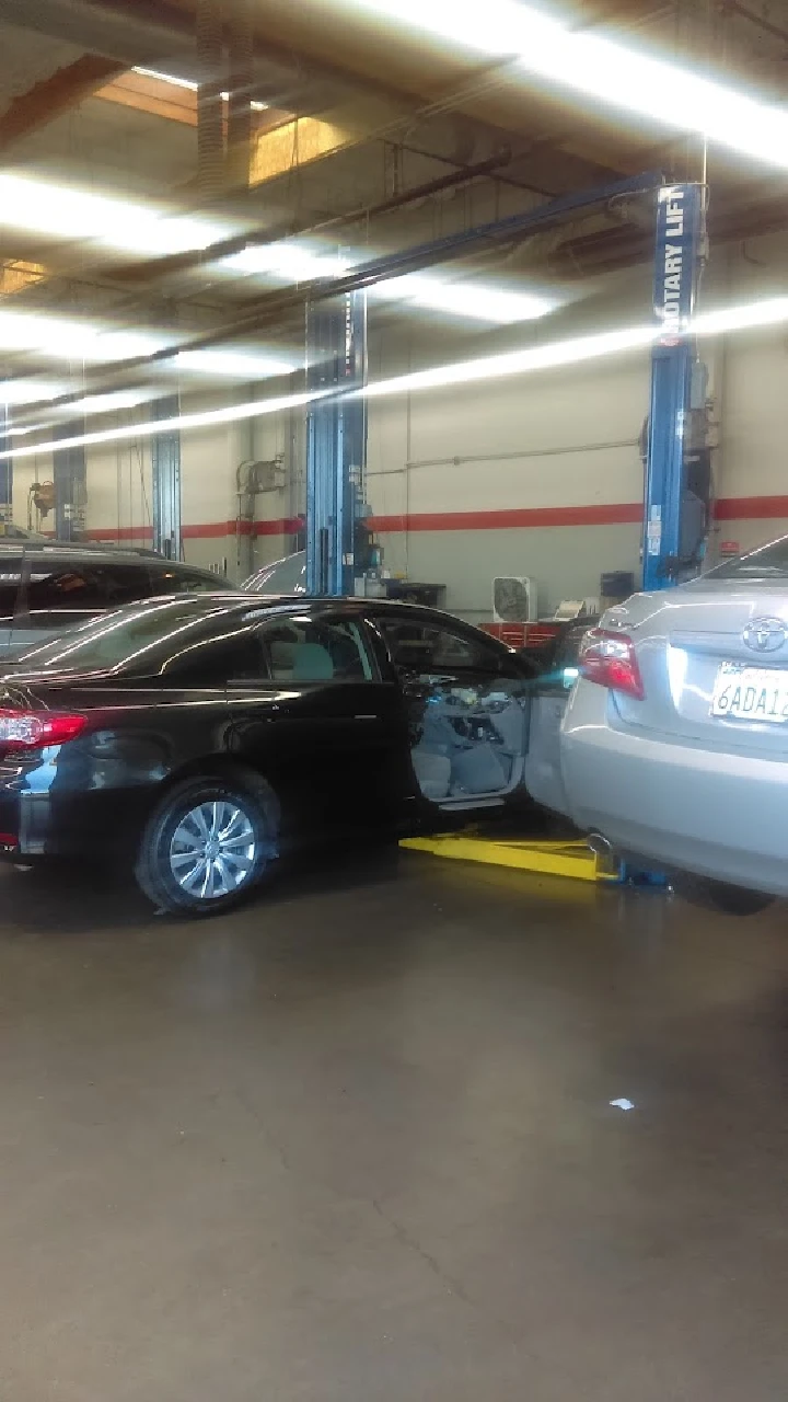 Toyota parts department with vehicles in service bays.