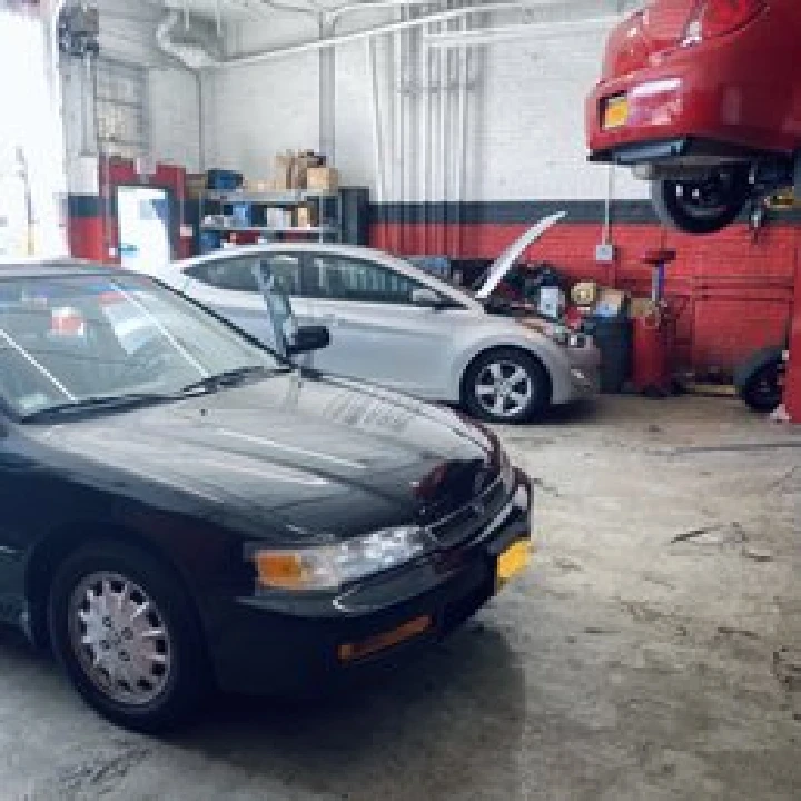 Two cars in an auto repair shop.