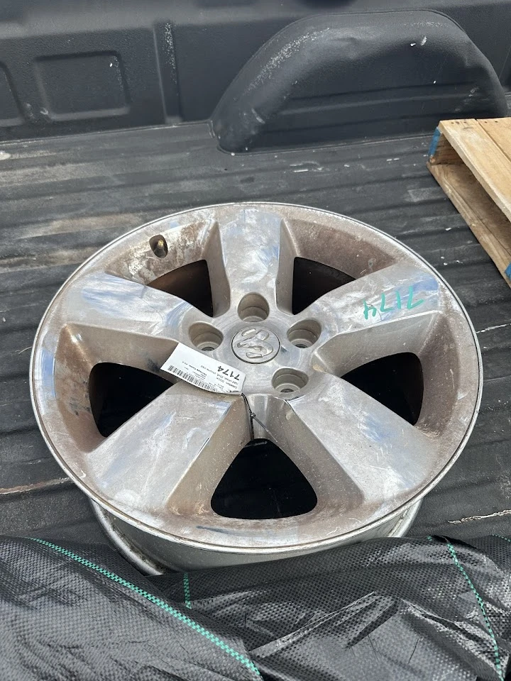 Used alloy wheel on a truck bed.