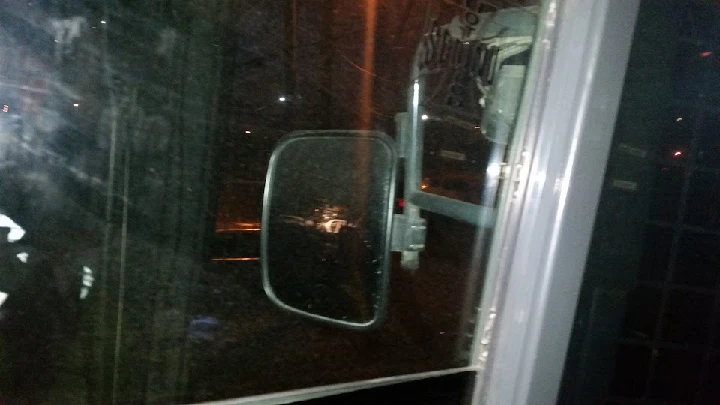 View of a truck's side mirror at night.