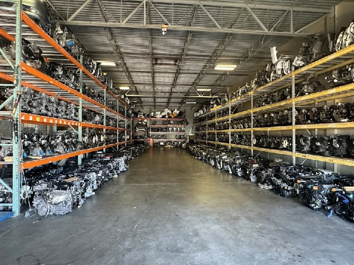 Warehouse filled with automotive engines and parts.