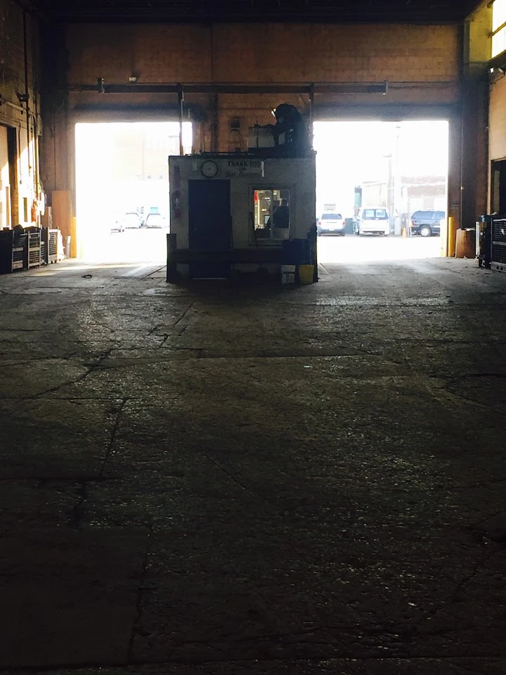 Warehouse interior with sunlight and machinery.