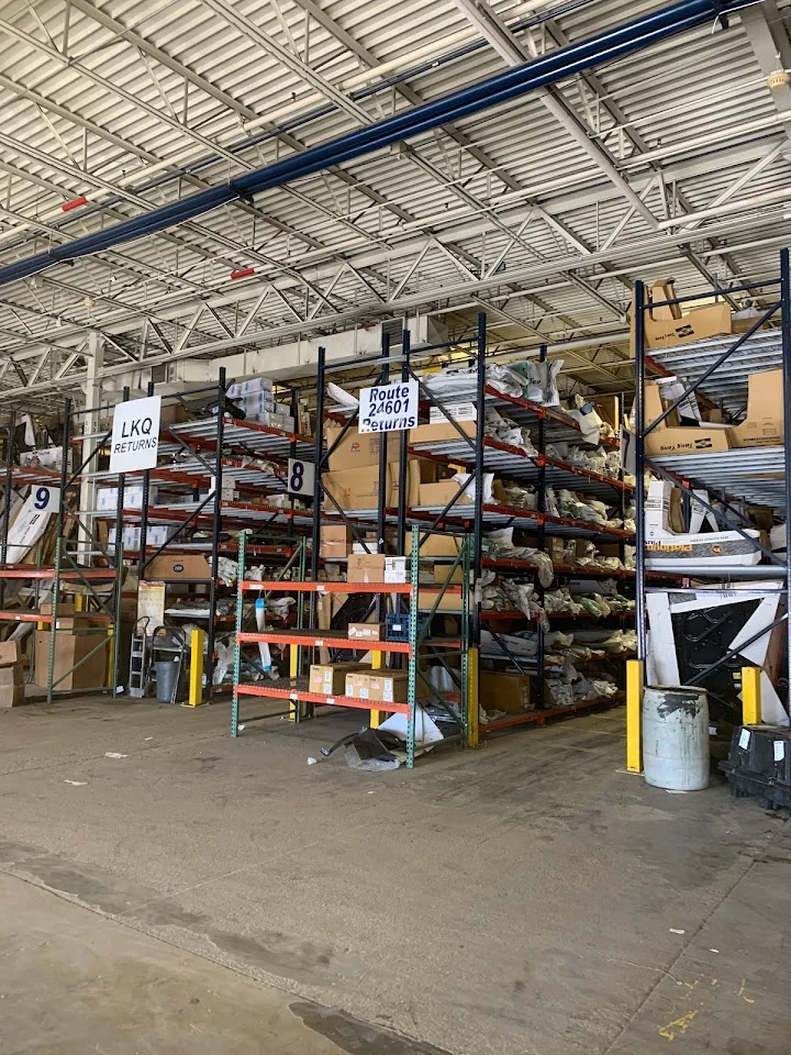 Warehouse shelves filled with boxes and returns.