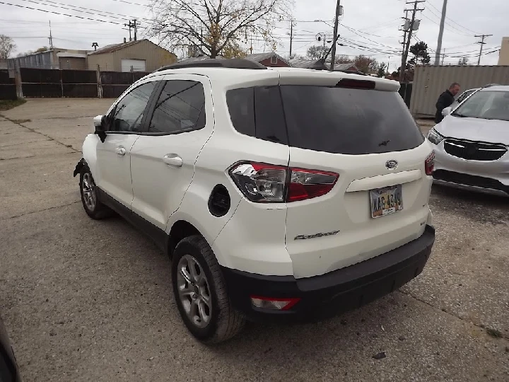 White SUV parked in a lot at Morad Parts Company.