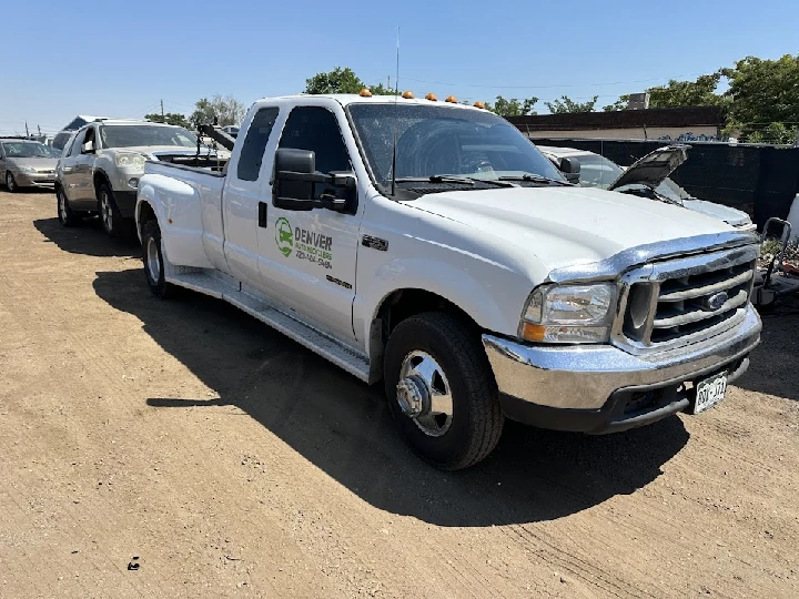 White tow truck at Denver Auto Recyclers site.