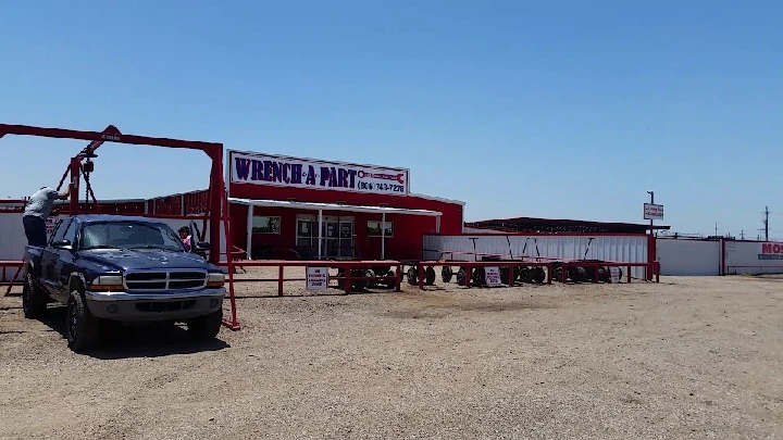 Wrench A Part store with a blue truck outside.