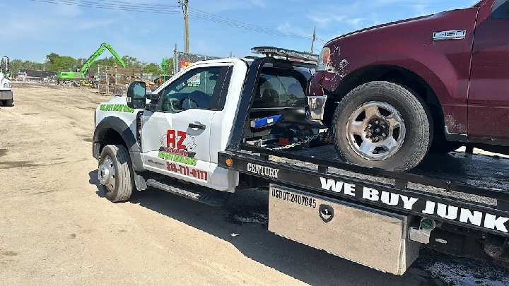 A&Z Junk Cars tow truck with a vehicle on the flatbed.