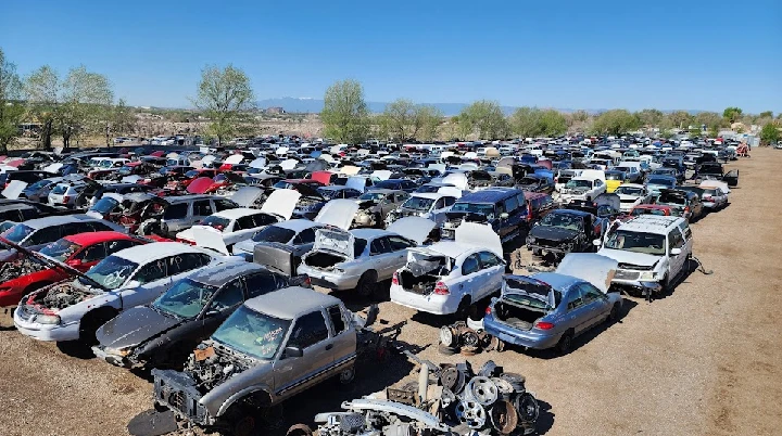 Aerial view of a junkyard filled with old cars.