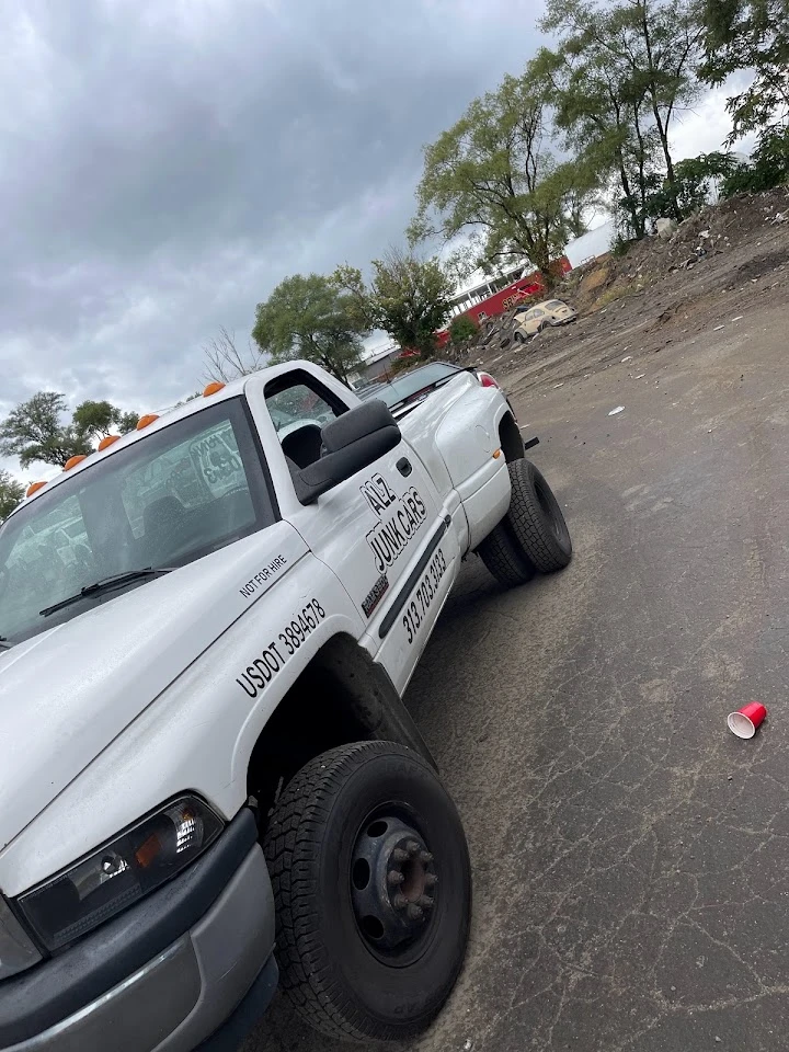 Alz Junk and Metal LLC truck parked on an empty lot.