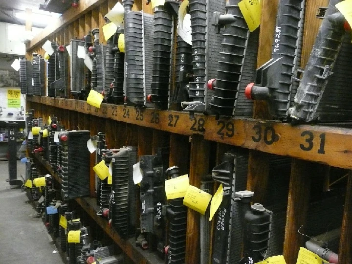 Auto parts displayed on wooden shelves with labels.