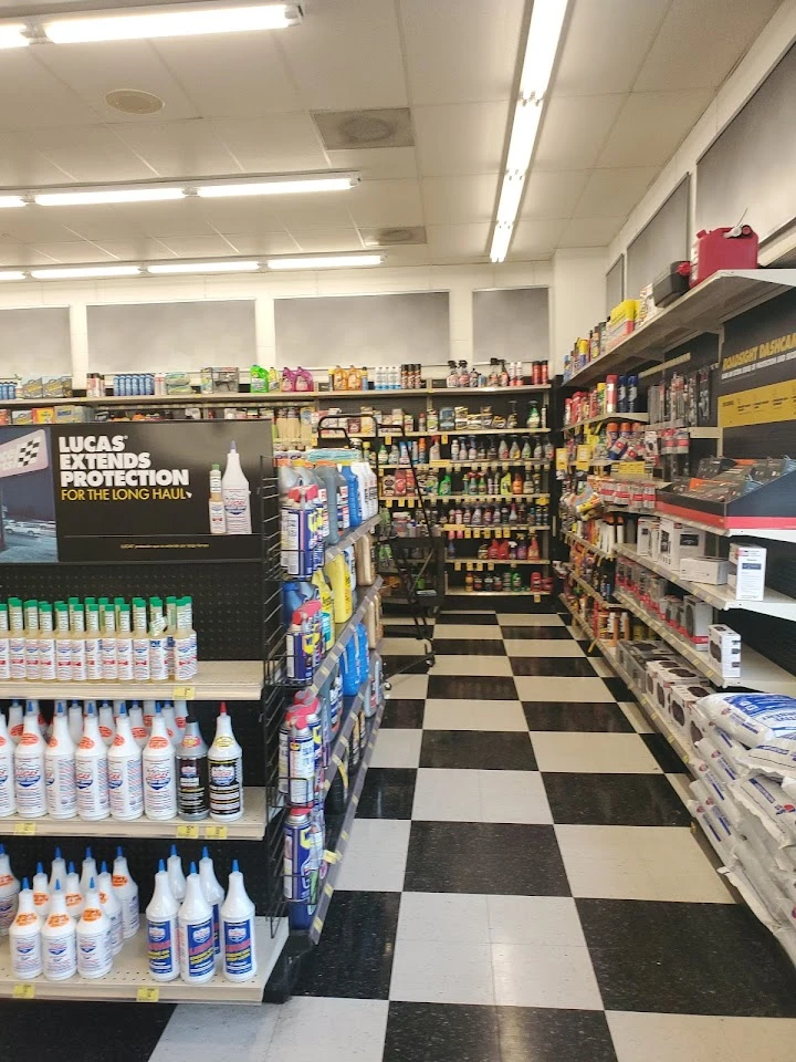 Auto parts store aisle filled with products and supplies.