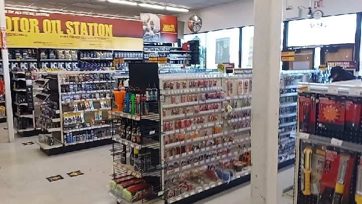 Auto parts store interior with oil station display.