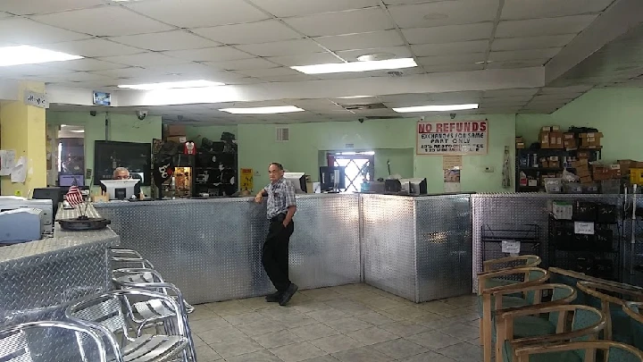 Auto parts store interior with staff at the counter.