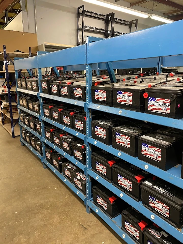 Auto parts store shelves filled with car batteries.