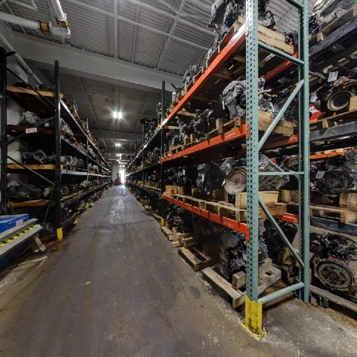 Auto parts warehouse filled with engines on shelves.