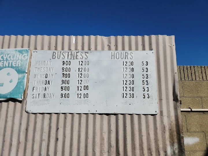 Business hours sign for Whittier Auto Dismantling.