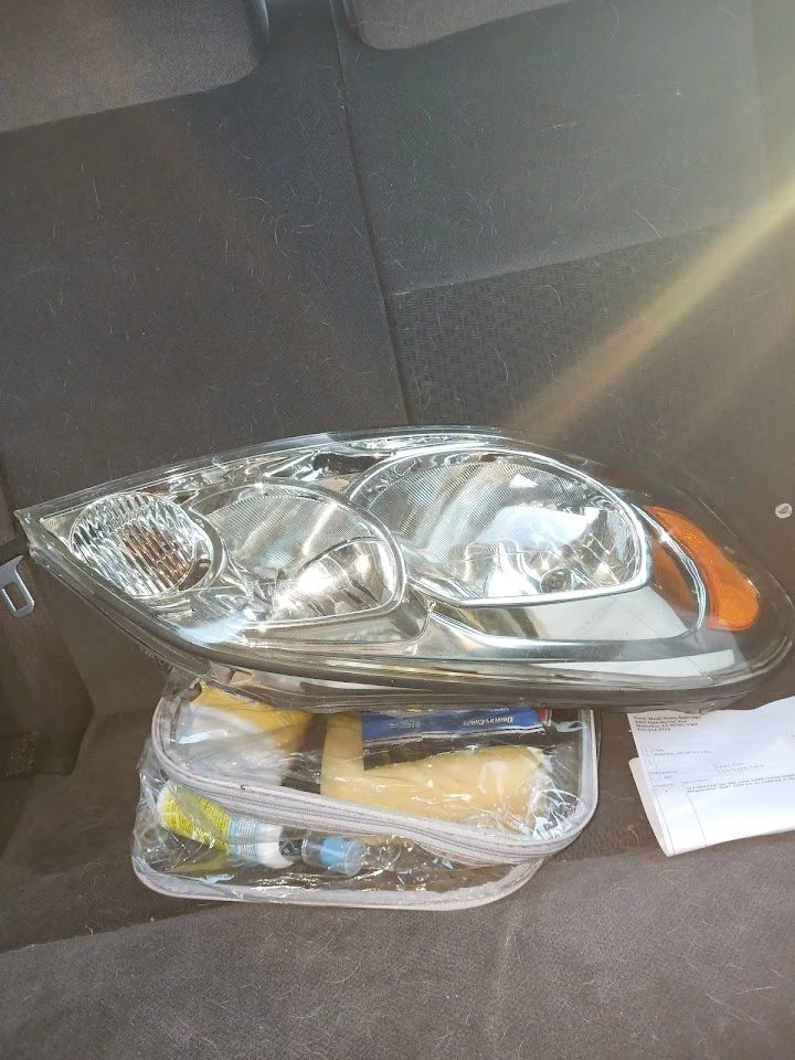 Car headlight and tools in a vehicle's backseat.