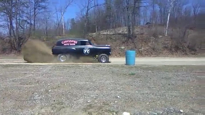 Chicopee Auto Farm vehicle kicking up dirt.