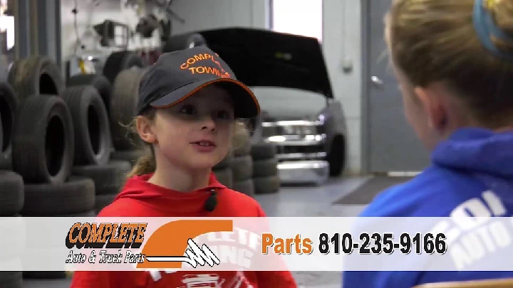 Child speaking in an auto parts shop.