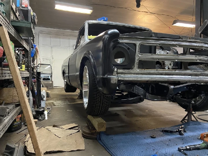 Classic car in restoration at an auto garage.