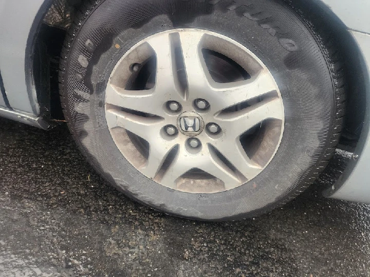 Close-up of a Honda tire and wheel rim.